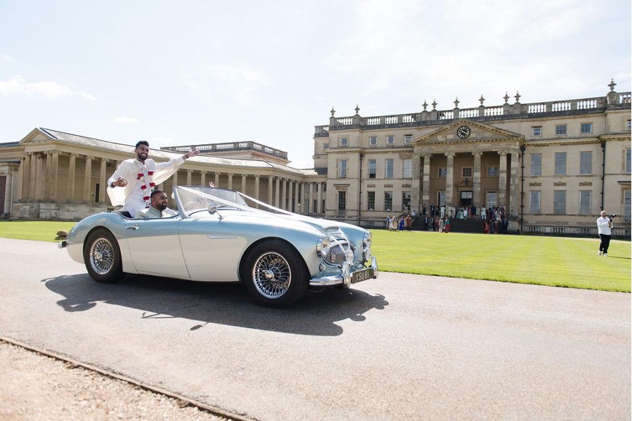 Classic car in front of mansion