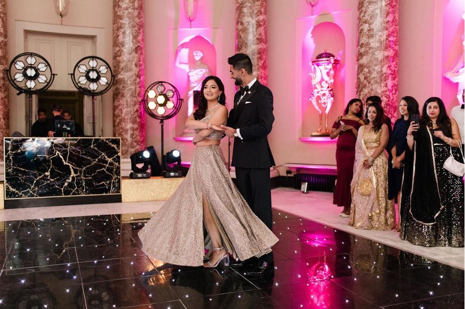 Elegant couple dancing at event.