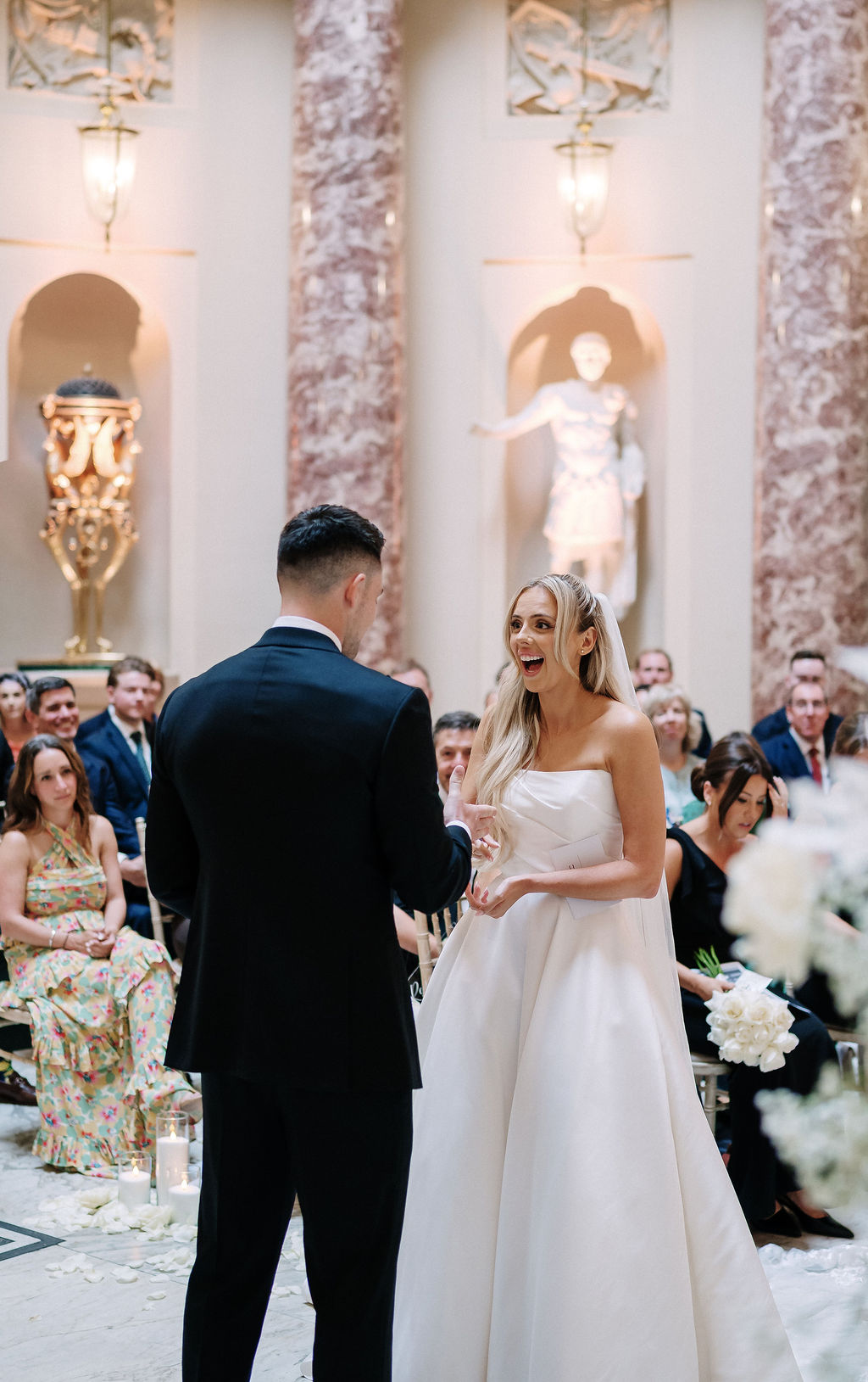 Couple exchanging vows in elegant setting.